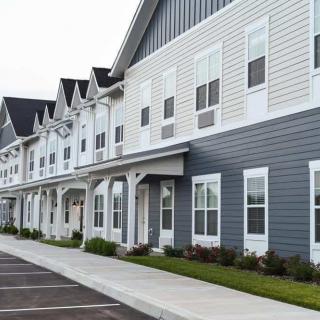 Row of modern townhouses with a uniform exterior design.