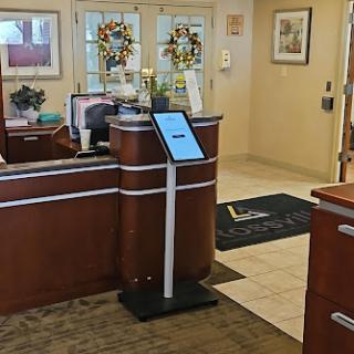 A welcoming reception area featuring a front desk and a digital information kiosk.
