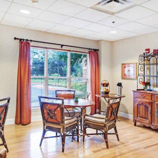 A cozy dining area featuring wooden furniture and natural lighting.