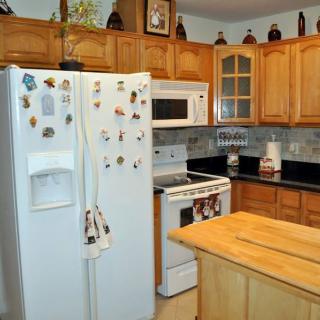 A cozy kitchen with wooden cabinets and modern appliances.