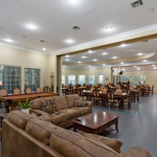A spacious interior with comfortable sofas and a large dining area.