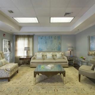 A modern living room featuring elegant furniture, artwork, and ambient lighting.