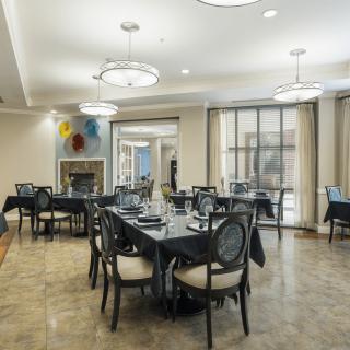 A modern dining area with elegantly set tables and stylish lighting.