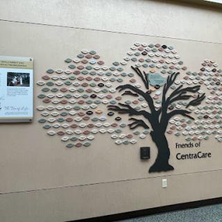 A decorative wall display featuring a tree made of ceramic pieces, representing the Friends of CancerCare.