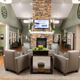 A welcoming lobby featuring comfortable seating, a cozy fireplace, and modern decor.