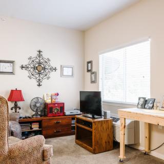 A cozy living room with a TV, comfortable seating, and decorative elements.