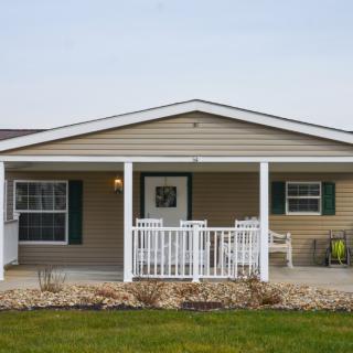 A single-story house with a front porch and lawn.