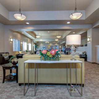 A beautifully designed lobby featuring modern furniture and floral decor.