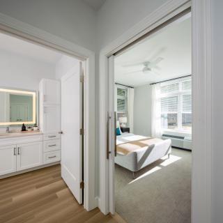 A modern and bright interior featuring a bedroom and bathroom with ample natural light.