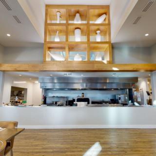 Modern restaurant interior with an open kitchen design.