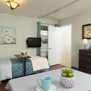 A cozy and well-decorated bedroom featuring modern furnishings and decorative elements.