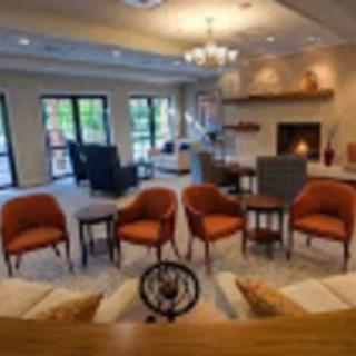 A cozy living room with comfortable seating and a fireplace.