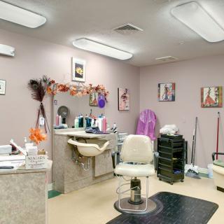 A cozy hair salon with styling chairs, mirrors, and vibrant decor.