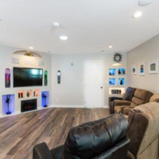 A modern home theater setup with comfortable recliners and stylish interior decor.