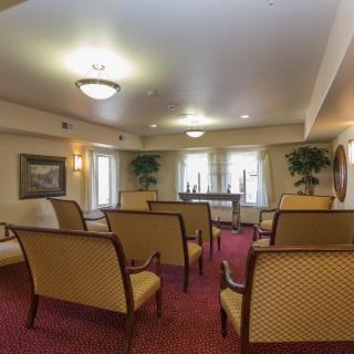 A well-appointed meeting room with arranged seating and soft lighting.