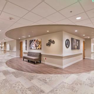 Modern hallway featuring seating and artwork displays