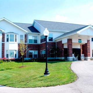 A suburban residential building with a well-maintained yard.
