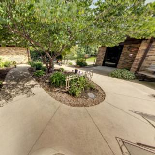 A beautifully landscaped garden with trees and a winding pathway.
