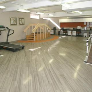 A spacious and modern gym interior with exercise equipment.