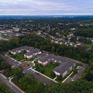 Aerial view of a suburban housing complex surrounded by trees.
