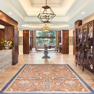 Elegant hotel lobby with intricate decor and chandelier.