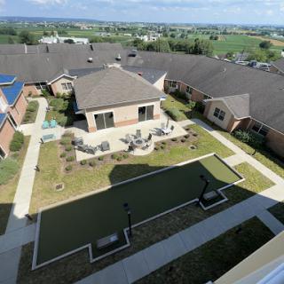 Aerial view of a residential courtyard featuring landscaped areas and seating arrangements.
