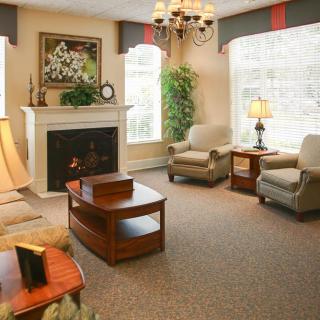 A cozy living room with elegant furniture and a warm fireplace.