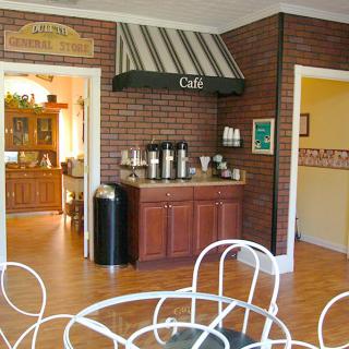Cozy cafe interior with a coffee station and seating area.