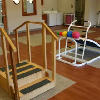 A physical therapy room equipped with rehabilitation tools and exercise equipment.