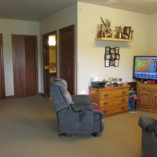 A cozy living room with a recliner and television.