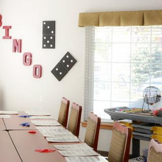A bingo game setup with tables and chairs in a decorated room.