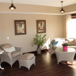A cozy and modern living room featuring stylish furniture and decorative wall art.
