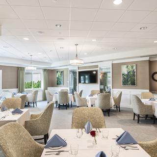 An elegant and modern restaurant dining area with neatly arranged tables and chairs.