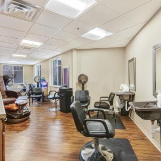 A modern hair salon interior with styling chairs and professional equipment.