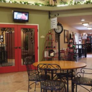 A cozy cafe interior with decorative lighting and seating arrangements.