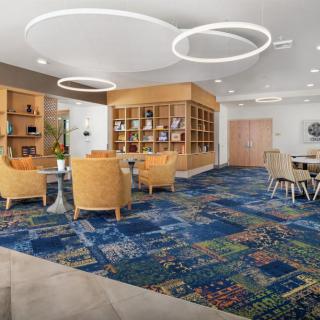A modern lobby with comfortable seating and stylish circular lighting.