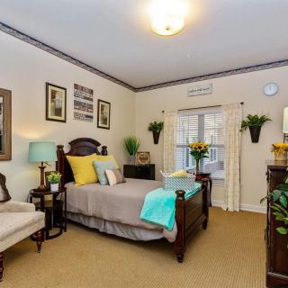 A cozy and elegantly decorated bedroom featuring a comfortable bed, stylish furniture, and tasteful decor accents.