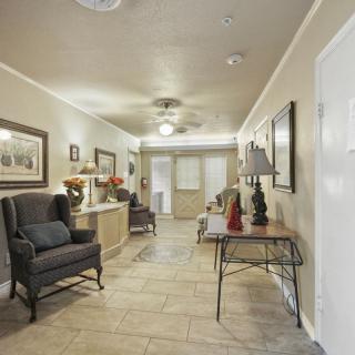 A well-decorated hallway featuring comfortable seating, artwork, and stylish lighting.
