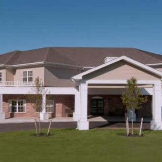A suburban residential building with a well-maintained lawn.