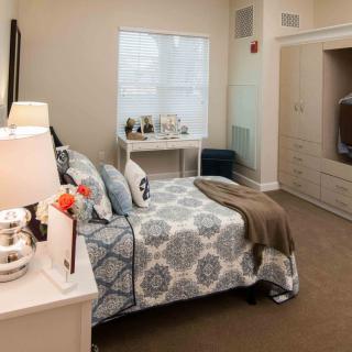 A cozy and modern bedroom with tasteful decor and furnishings.
