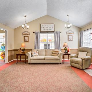 A cozy living room with a sofa, armchair, and decorative lamps.