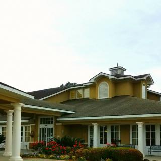 A residential building with landscaped surroundings.