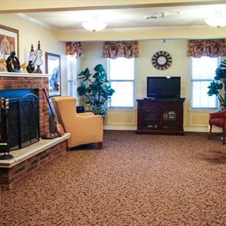 A cozy living room featuring a fireplace, television, and comfortable seating.