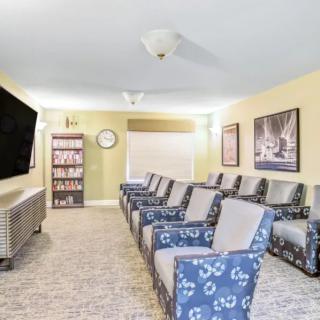A cozy home theater setup with comfortable seating and a large television.