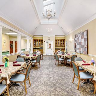 Elegant dining room with neatly arranged tables and bright, inviting lighting.