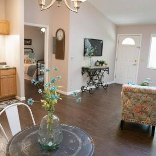 A cozy living space featuring an open floor plan with a dining area and adjacent kitchen.