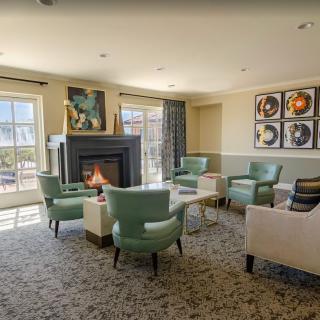 A cozy living room with a fireplace and stylish seating.