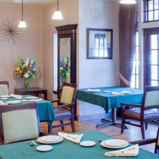 A beautifully arranged dining area featuring green tablecloths and elegant decor.