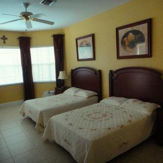 A cozy bedroom with twin beds and elegant decor.