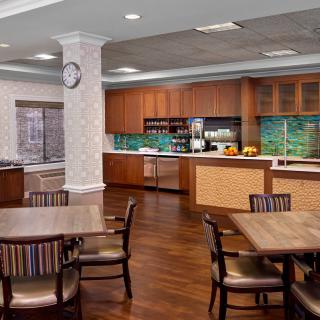 A modern kitchen and dining area with wooden furniture and countertops.